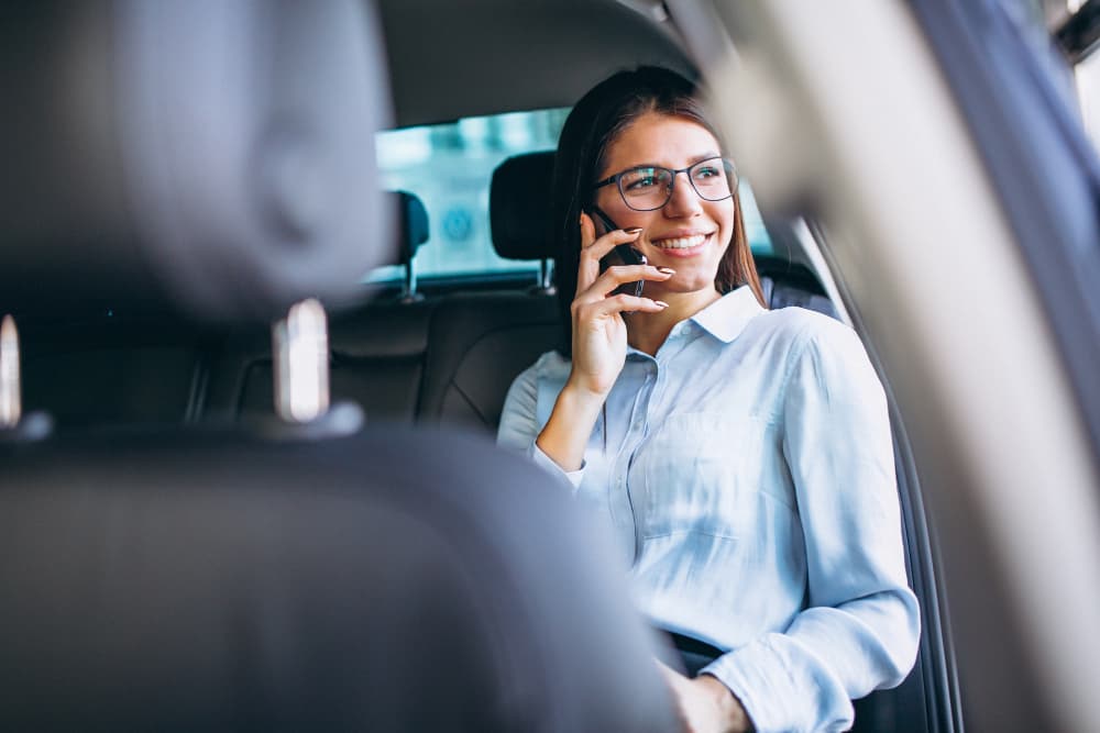 Professional speaking on the phone in a car